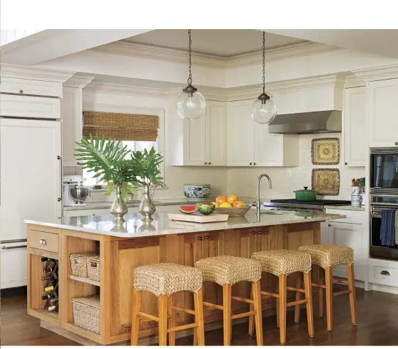  ??  ?? |ABOVE| EATING LOCAL. To give the kitchen a fresh look, Cameron assisted the homeowners in selecting new stone, tile and paint options that paired with the woven rattan stools and the custom island. The island is made from local cypress wood with a...