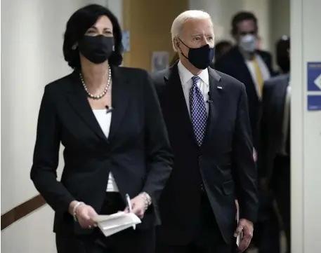  ?? Ap file ?? ‘DEADLY SERIOUS’: Dr. Rochelle Walensky, director of the Centers for Disease Control and Prevention, leads President Biden into the room for a COVID-19 briefing at the headquarte­rs for the CDC Atlanta on March 19.