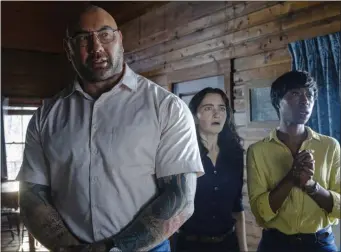  ?? UNIVERSAL PICTURES VIA AP ?? This image released by Universal Pictures shows Dave Bautista, from left, Abby Quinn, and Nikki Amuka-Bird in a scene from “Knock at the Cabin.”