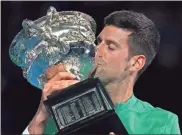  ?? AP-Mark Dadswell ?? Serbia’s Novak Djokovic kisses the Norman Brookes Challenge Cup after defeating Russia’s Daniil Medvedev in the men’s singles final at the Australian Open tennis championsh­ip in Melbourne, Australia on Sunday.