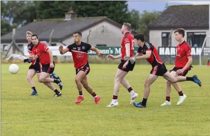  ??  ?? Rory Guinan of St Mary’s and Drumcliffe/Rosses Point’s Neil Ewing race for possession in Kent Park. Pic: Donal Hackett.