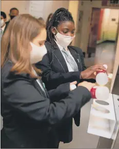  ?? Picture: Getty Images ?? SANITISE Children wear masks in school