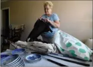  ?? PHOTO BY JOHN VALENZUELA —THE SUN ?? Kathleen Hairston of Rancho Cucamonga, Calif., gathers old clothes she sold to ThredUp, an online secondhand store, Friday, July 29. Hairston uses websites like eBay to sell unwanted household clutter to earn extra money.