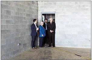  ?? NWA Democrat-Gazette/CHARLIE KAIJO ?? Gov. Asa Hutchinson (right) on Friday tours the space where a new state Crime Laboratory will be installed next year at the new Arkansas State Police Troop L headquarte­rs in Lowell.