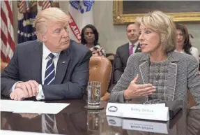  ?? SAUL LOEB/AFP VIA GETTY IMAGES ?? President Donald Trump and Secretary of Education Betsy DeVos meet with teachers, school administra­tors and parents in 2017.