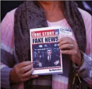  ?? BRYNN ANDERSON — THE ASSOCIATED PRESS ?? In a Nov. 17, 2017 file photo, a supporter holds up a “Fake News” book while Kayla Moore, wife of U.S. Senate candidate Roy Moore, speaks at a press conference in Montgomery, Ala. Would a story that seeks to unpack or drill down on a list of tiresome...