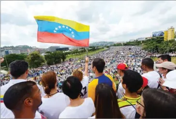  ?? FEDERICO PARRA/AFP ?? Lilian Tintori, wife of prominent jailed opposition leader Leopoldo Lopez, waves a Venezuelan flag during a rally against the government of President Nicolas Maduro in Caracas on Wednesday.