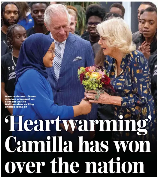  ?? ?? Warm welcome...Queen receives a bouquet on a recent visit to Walthamsto­w as King Charles looks on