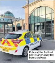  ??  ?? Police at the Trafford Centre after a boy fell from a walkway