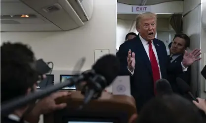  ?? Photograph: Evan Vucci/AP ?? Donald Trump talks to reporters aboard Air Force One after a campaign rally in New Hampshire on Friday. Joe Biden, his Democratic rival, has directly tied Trump’s rhetoric to such incidents of violence.