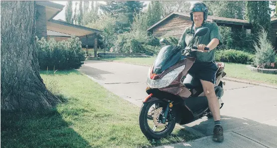  ?? PHOTOS: HONDA CANADA ?? Ron McLean proudly astride his Honda PCX 150 at his home in Edmonton. He traded in his first scooter, a Honda Elite 150, after 8,484 kilometres of driveway travel.