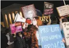  ?? Roberto Schmidt / AFP / Getty Images ?? Antiaborti­on activists and Barrett supporters gather outside Supreme Court.