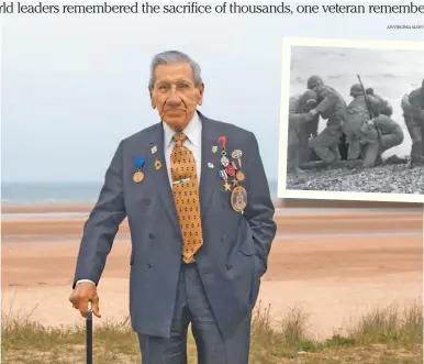  ??  ?? World War II and D-Day veteran Charles Norman Shay, from Indian Island, Maine, poses on a dune at Omaha Beach in Saint-Laurent-sur-Mer, Normandy, France. Shay was a medic who on June 6, 1944, landed on Omaha Beach, where he helped drag wounded soldiers out of the rising tide, saving them from drowning. For his courage, he was awarded the Silver Star.