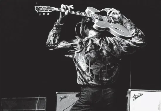  ?? Gijsbert Hanekroot Redferns ?? PLAY HIS GUITAR behind his head? No problem for Chuck Berry, showing he’s still got it 20 years after he helped birth rock ’n’ roll, in Amsterdam in 1976.