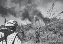  ?? Marcus Yam / Tribune News Service ?? Inmate firefighte­rs clear brush to slow down the spread of the Maria Fire on Friday in Santa Paula, Calif. Evacuation orders for Somis were lifted as the fire was 20 percent contained.