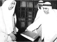  ??  ?? Sheikh Abdullah Al-Salem Al-Sabah receives a draft of the Constituti­on of Kuwait from Abdullatif Al-Ghanem.