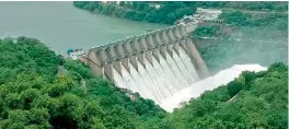  ??  ?? All 10 crest gates of Srisailam dam were opened on Sunday after the reservoir was filled due to heavy rains upstream in the last few days.