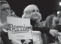  ??  ?? A supporter watches the stage at the Colorado Convention Center during Sen. Bernie Sanders’ rally Sunday.