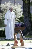  ?? ALESSANDRA TARANTINO - THE AP ?? In this photo taken on Friday, Oct. 4, Pope Francis walks past wooden statues portraying naked pregnant women as he arrives to attend a tree planting rite with members of Amazon indigenous population­s, in the Vatican gardens.