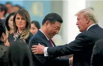  ?? PHOTO: REUTERS ?? United States First Lady Melania Trump watches as President Donald Trump and China’s President Xi Jinping continue their bonding at a state dinner at the Great Hall of the People in Beijing.