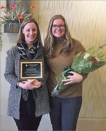  ?? Contribute­d photo / Family Centers ?? Julianne Green, left, and Chelsea McGee of Family Centers pose in January as they accept an award for their contributi­ons in the field of palliative and end-of-life care.