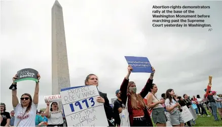  ?? AP ?? Abortion-rights demonstrat­ors rally at the base of the Washington Monument before marching past the Supreme Court yesterday in Washington.