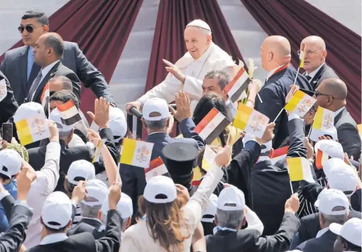  ?? AMR NABIL, AP ?? Pope Francis waves as he arrives to celebrate Mass for Egypt’s tiny Catholic community Saturday in Cairo.