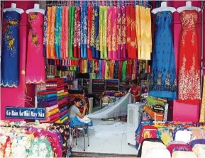  ??  ?? There is a fabric market in District 5 where you will find rows of fabric shops. — S.S. YOGA