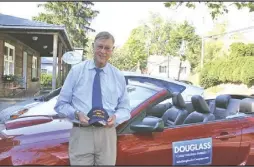  ?? Photo by Roger Piantadosi/rappahanno­ck News ?? Gen. John Douglass chats on Main Street in Washington, leaning on the latest in a series of Mustang convertibl­es that date to his days as a military consultant in Europe.