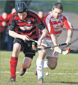  ?? Photograph: Stephen Lawson. ?? Oban Camanachd’s Andrew ‘Papa’ MacCuish and Lochaber’s Donald MacRae in a race for the ball during last Saturday’s Marine Harvest Premiershi­p match at Mossfield which the red and blacks won 7- 0.