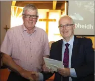  ??  ?? Martin Kennedy receiving a presentati­on from the parish by Willie Fitzharris.