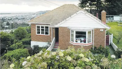  ?? PHOTO: GERARD O’BRIEN ?? One of Dunedin’s original state houses, in Hislop St, Pine Hill.