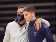  ?? Laurence Kesterson / Associated Press ?? Villanova coach Jay Wright, left, and guard Collin Gillespie are shown before an NCAA basketball game against Creighton in Villanova, Pa., on March 3. The Big East updated its COVID policy on Thursday.