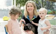  ??  ?? Rosie the rabbit is held by Helen Blackburn, a staff member at the Remuera daycare, with Chloe and Ella.