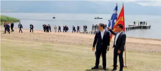  ??  ?? FYROM Prime Minister Zoran Zaev (r) and Greece’s Alexis Tsipras react after the signing of an accord to settle the name dispute between their two countries on Sunday.