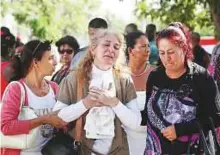  ?? Reuters ?? Relatives mourn the victims of the Boeing 737 plane that crashed after taking off from Havana airport yesterday,