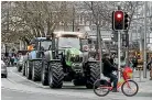  ??  ?? Tractors in the Groundswel­l protest protest drive past the Cathedral Square in Christchur­ch on Friday.