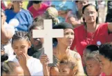  ?? Picture: EUGENE COETZEE ?? CALL FOR PEACE: Mieta Hare (holding a cross) and other concerned Helenvale residents at a peace event in the suburb yesterday