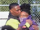  ?? ANGELA PETERSON / MILWAUKEE JOURNAL SENTINEL ?? Marlin Dixon, left, embraces his daughter, Kamariya Dixon, after he was released from the John C. Burke Correction­al Center. His daughter was 5 months old when he was sentenced to 18 years in prison for killing Charlie Young Jr.