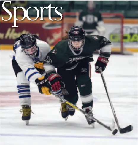  ?? CITIZEN PHOTO BY BRENT BRAATEN ?? Logan Forman of the College Heights Cougars, left, and Jordan McMillan of the PGSS Polars race for the puck during the first period of the 15th annual Spirit of Hockey and Community Cup game on Friday afternoon at CN Centre.