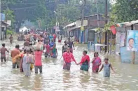  ??  ?? BALURGHAT: This file photo taken on August 17, 2017 shows Indian residents wading through flood waters. —AFP