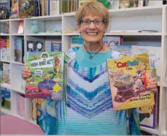  ??  ?? Award-winning American author, Kathy Brodsky, displaying two of her numerous books