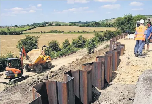  ??  ?? Work goes on to repair the landslip