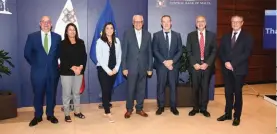  ?? ?? Central Bank Governor Edward Scicluna together with ECB officials and staff within the Banking Operations Division at the Central Bank of Malta.