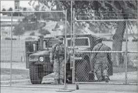  ?? RAQUEL NATALICCHI­O/HOUSTON CHRONICLE VIA AP ?? National Guard and other law enforcemen­t are stationed Wednesday at a now closedoff Shelby Park in Eagle Pass, Texas.