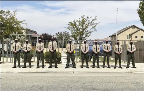  ?? LANCASTER SHERIFF’S STATION FACEBOOK PAGE ?? Deputies stand in front of the apartment complex where Sgt. Steve Owen was shot and killed four years ago. The deputies begin their shifts at midnight on Oct. 5 each year and hold vigil for 24 hours.