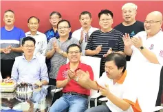  ??  ?? Past president of Shosa Robert Lau Hui Yew (seated left) was given two surprise birthday cakes during the Shosa meeting on Saturday as Yong (seated second from left) and other officials and former students sang the birthday song for him.