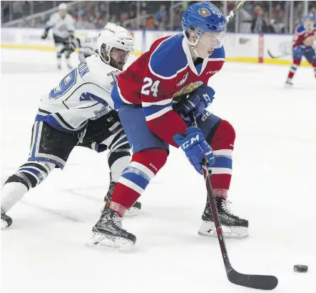  ?? IAN KUCERAK ?? Brett Kemp of the Oil Kings fends off the checking of Victoria’s Dante Hannoun Wednesday during the second period of their game at Rogers Place during a thrilling 3-2 overtime win by the visiting Royals.