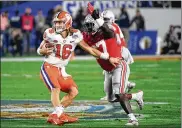  ?? NORM HALL / GETTY IMAGES ?? Clemson’s Trevor Lawrence is hit by Ohio State’s Robert Landers in the first half Saturday in the College Football Playoff Semifinal at the PlayStatio­n Fiesta Bowl at State Farm Stadium in Glendale, Ariz.
