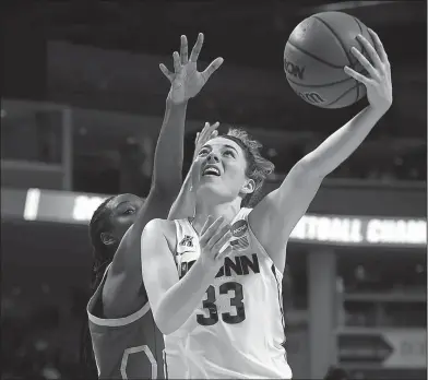  ?? Associated Press ?? Hook shot: Connecticu­t's Katie Lou Samuelson shoots as UCLA's Kennedy Burke, left, defends during the second half of a regional semifinal game Saturday in Bridgeport, Conn.